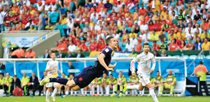 An airborne Robin van Persie of Holland scoring against world champions Spain.