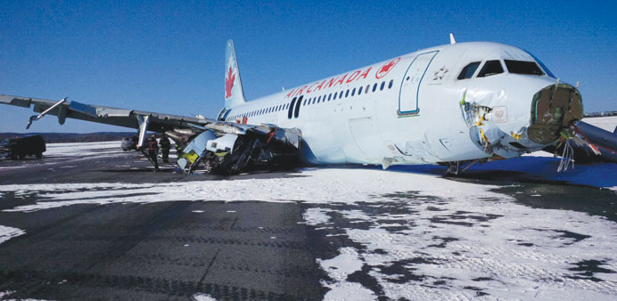 An Air Canada Airbus A320 lies in the snow after it skidded off the runway at Halifax International Airport, Nova Scotia yesterday. At least 23 passen