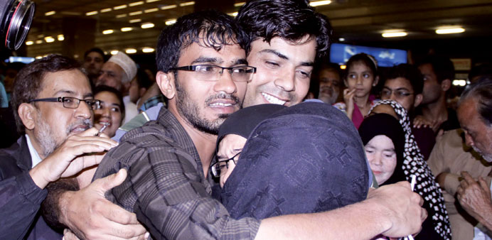 Pakistani families, evacuated from Yemen, are greeted by relatives on their arrival in Jinnah International Airport in Karachi yesterday.