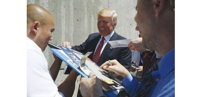 Trump signs autographs in Ames.