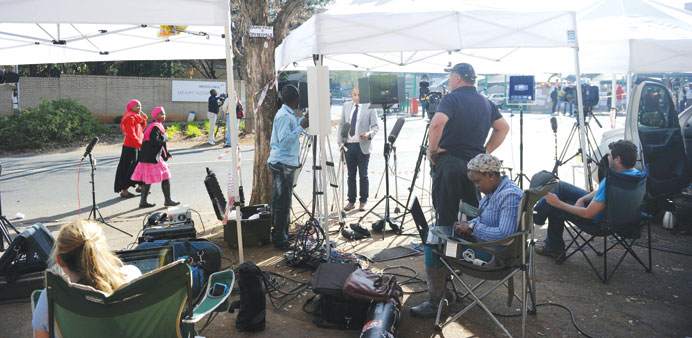 Journalists wait outside the Medi-Clinic Heart Hospital in Pretoria where former South African president Nelson Mandela is admitted.