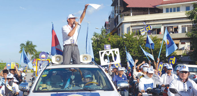 Supporters of the Cambodia National Rescue Party (CNRP) shout slogans during the general election campaign in Phnom Penh yesterday.