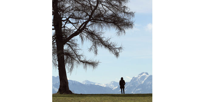 * A woman looks at the Alps near Marktoberdorf, southern Germany. Meteorologists forecast unsettled weather for the coming days in Germany.