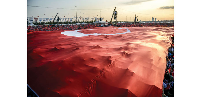 Supporters hold a giant Turkish national flag during a rally in Istanbul.