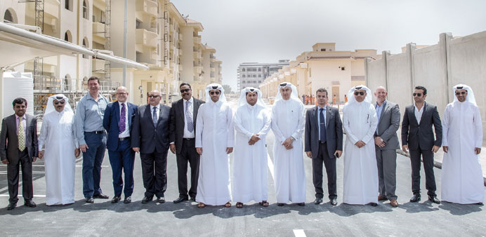 The delegation poses for a photo at the site.