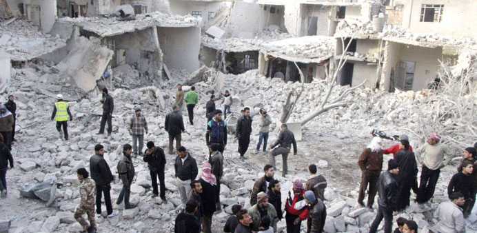 Residents search for survivors after what activists said was an air strike by regime forces in the Tareek Al-Bab area of Aleppo yesterday.
