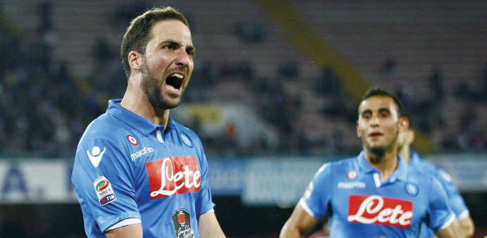 Napoliu2019s forward Gonzalo Higuain celebrates after scoring during the Italian Serie A football match against AC Milan.