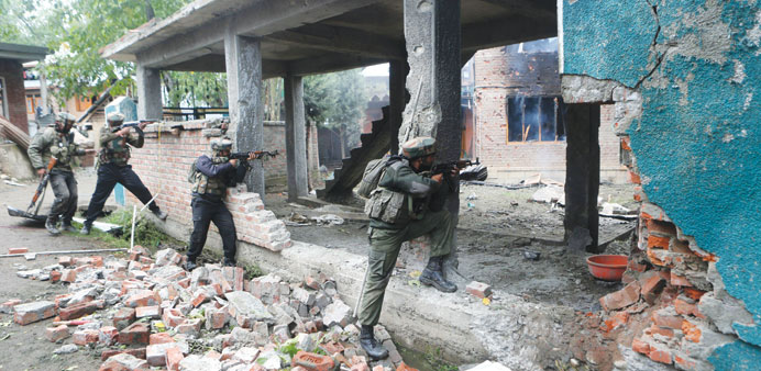 Soldiers fire towards a house in which militants were holed up in Rajpora area of Pulwama, south of Srinagar yesterday.