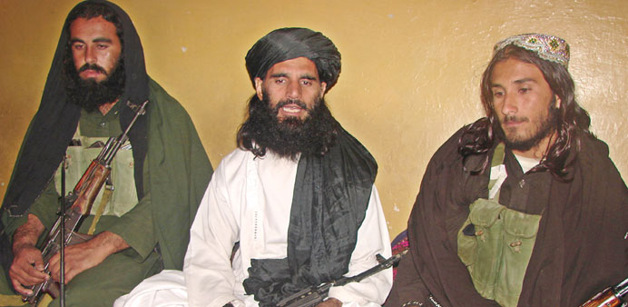 This undated photograh shows Asmatullah Shaheen (centre), a former interim chief of a militant group, talking with media in an undisclosed location in