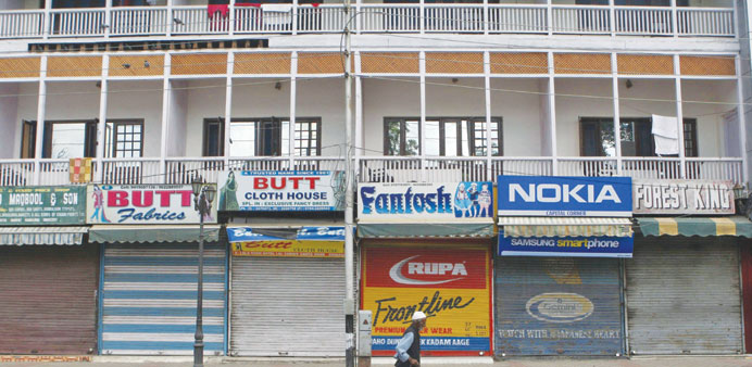 A man walks past closed shops during a shutdown in Srinagar, the summer capital of Jammu and Kashmir yesterday.