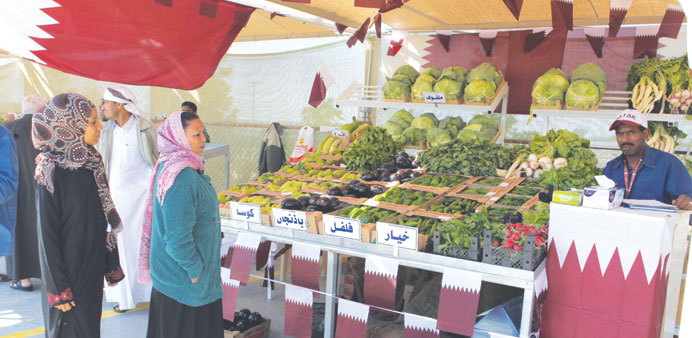 People visiting a vegetable stall at Al-Mazrouah Yard on Thursday. PICTURE: Othman al-Samarraee