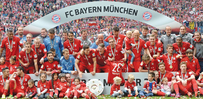 Bayern Munichu2019s players celebrates wining their 25th Bundesliga title after at the Allianz Arena in Munich. (AFP)