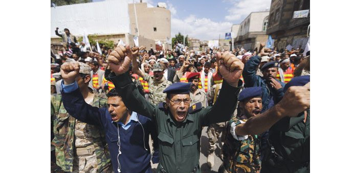 Army and police officers loyal to the Houthi Shia group demonstrate near the cabinetu2019s headquarters in Sanaa yesterday.