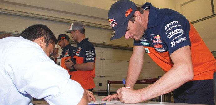 Marc Coma completes pre-race formalities at the Losail International Circuit yesterday.