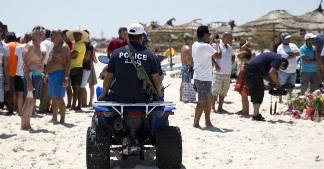 Tunisian policemen patrol the beach in front of the Riu Imperial Marhaba Hotel in Port el Kantaoui, on the outskirts of Sousse south of the capital Tu