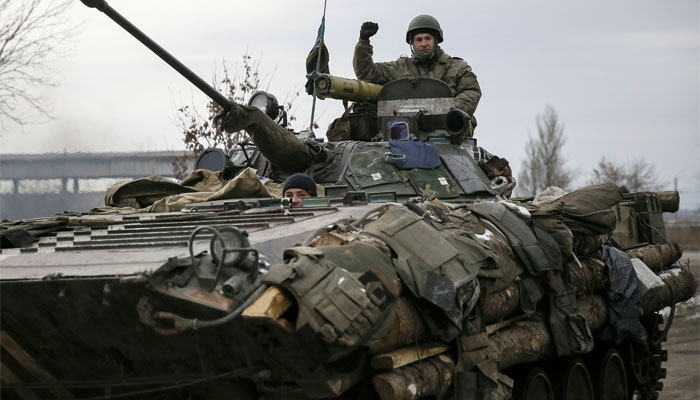 A Ukrainian serviceman rides on a military vehicle near Artemivsk 