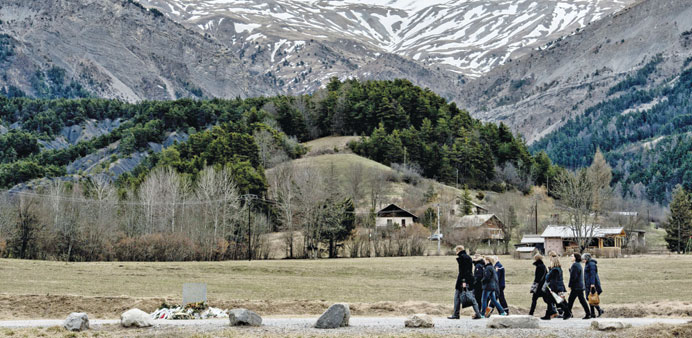 People arrive to pay tribute to the victims of the Germanwings flight that crashed in the French Alps, at a memorial in le Vernet, southeastern France