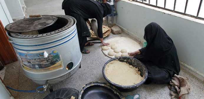 Displaced Yemeni women make bread at a school turned into a shelter in Sanaa.
