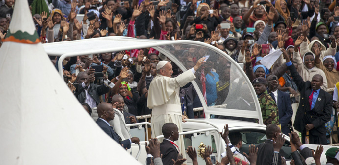 Pope Francis waves to the crowd at the University of Nairobi