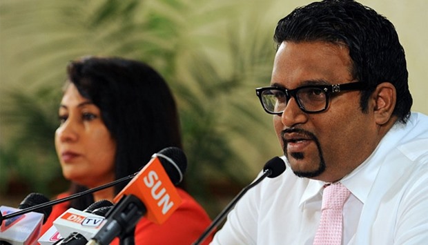 In this photograph taken on November 11, 2013, former Maldives tourism minister and deputy leader Ahmed Adeeb (R) speaks while Maldives Acting Minister for Foreign Affairs Mariyam Shakeela looks on during a press conference in Male.