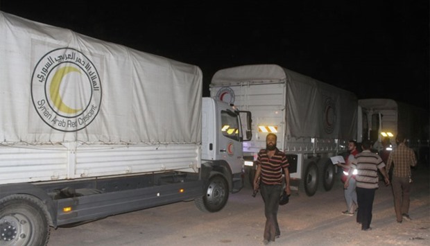 A United Nations and Syrian Arab Red Crescent aid convoy enters the Syrian rebel-held town of Daraya late yesterday.