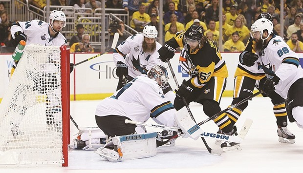San Jose Sharks goalie Martin Jones (left) makes a save as Pittsburgh Penguins Carl Hagelin looks for the puck in game five of the 2016 Stanley Cup final at Consol Energy Center in Pittsburgh.  (USA TODAY Sports)