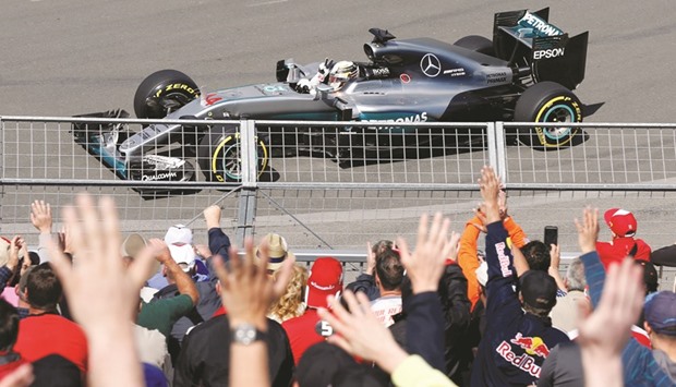 Mercedes driver Lewis Hamilton gestures towards the crowd during the first practice for the Canadian Grand Prix in Montreal, Canada, yesterday. (Reuters)