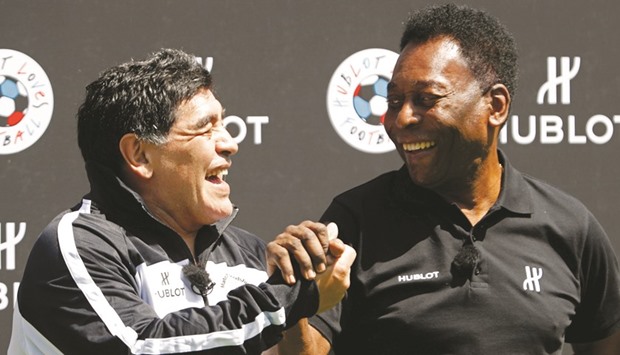 Football legends Pele (right) and Diego Maradona greet each other during an event in Paris. (Reuters)