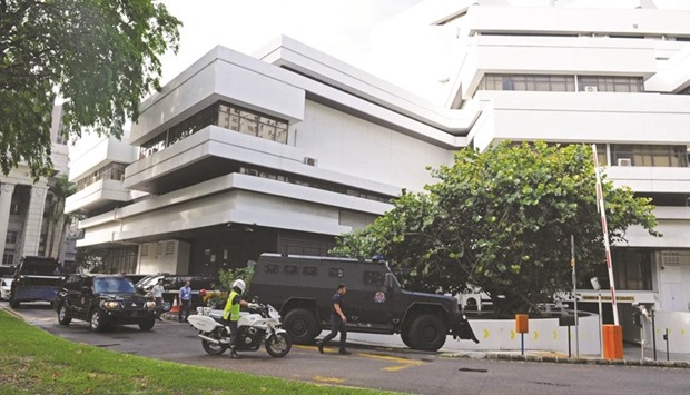 One of the three police armoured vehicles transporting six arrested Bangladeshi guest workers arriving at the Singapore State Courts yesterday.