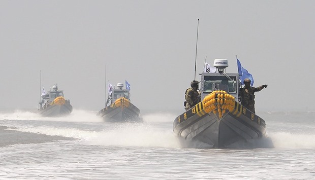 South Korean patrol boats conducting an operation to drive out Chinese fishing boats from neutral waters close to the disputed sea border with North Korea yesterday.