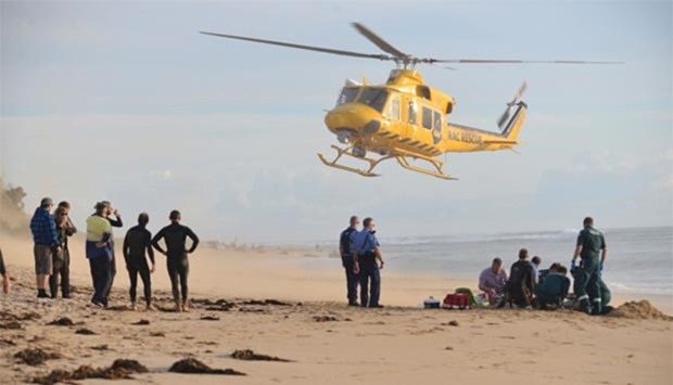 A rescue helicopter arrives to transport a critically injured surfer after a shark ripped off his leg in an attack at Falcon Beach, south of Perth.