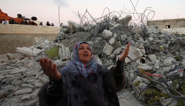 Maha the mother of of 15-year old Palestinian teenager Murad Ideis, who was accused of stabbing to death a 38-year old Israeli nurse in an attack in the Israeli Otniel settlement in January 2016, reacts next to the rubble of her home after Israeli security force demolished the building in the West Bank village of Beit Amra, south of Hebron on June 11, 2016