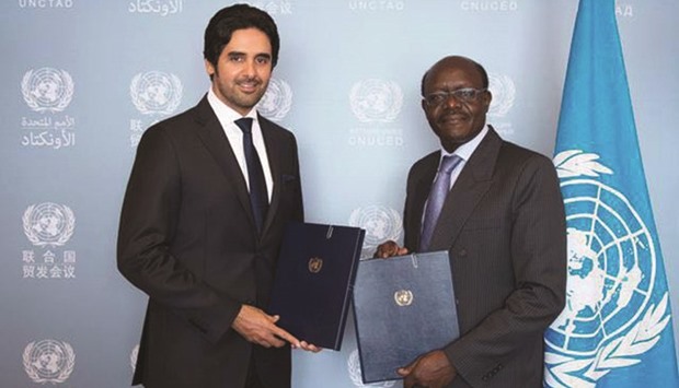 Faisal bin Abdullah al-Henzab with Mukhisa Kituyi after signing the agreement in Geneva.