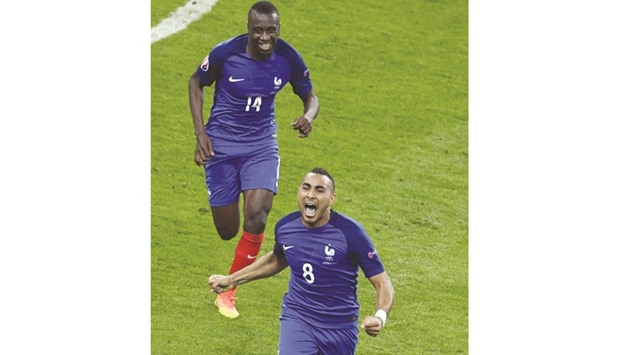 Dimitri Payet, right, celebrates scoring the 2-1 goal with midfielder Blaise Matuidi during the Euro 2016 group A football match between France and Romania at Stade de France, in Saint-Denis, north of Paris, yesterday.