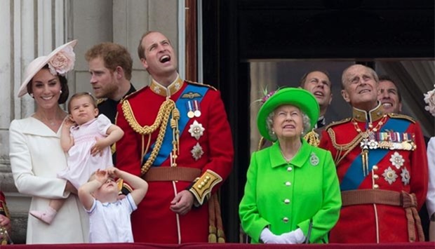 Britain's Catherine, Duchess of Cambridge holding her daughter Princess Charlotte, Prince George, Prince William, Duke of Cambridge, Queen Elizabeth II and Prince Philip, Duke of Edinburgh stand on the balcony of Buckingham Palace to watch a fly-past of aircraft by the Royal Air Force, in London on Saturday. 