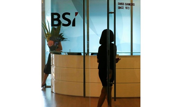 An employee enters the reception area of BSIu2019s office in Singapore. The Swiss bank is at the centre of the widening financial scandal involving 1MDB.