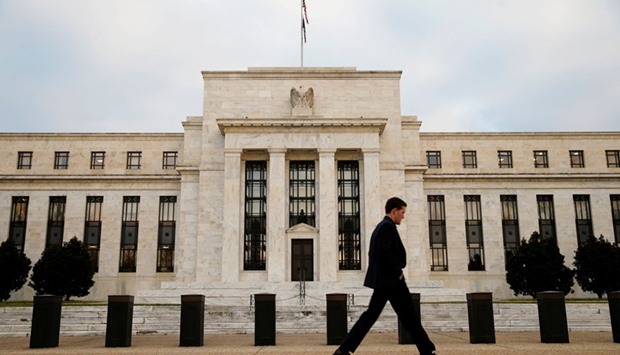 A man walks past the Federal Reserve Bank in Washington. While the Fed, Bank of England, Swiss National Bank and the Bank of Japan are all dealing with varying amounts or shortages of inflation, none are expected to act ahead of one of the biggest risk events of 2016.