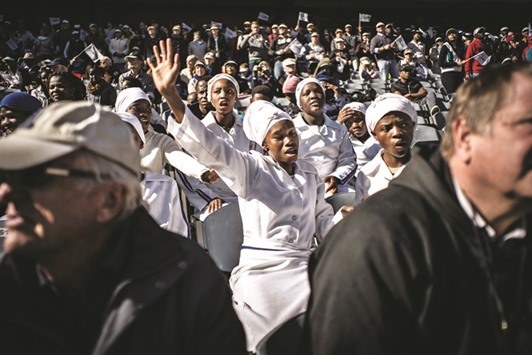 Members of traditional churches pray at the Orlando Stadium in Soweto yesterday during a ceremony to commemorate the 40th anniversary of the Soweto uprising.