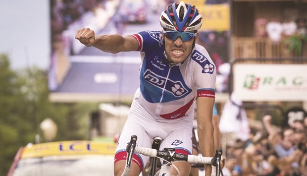 FDJu2019s French rider Thibaut Pinot celebrates his stage victory on the finish line during the sixth stage of the 68th edition of the Dauphine Criterium cycling race in Meribel yesterday. (AFP)