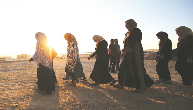 Palestinian women walking at sunrise towards the Qalandia checkpoint, a main crossing point between the West Bank city of Ramallah and occupied Jerusalem yesterday, as they head to Jerusalemu2019s Al-Aqsa mosque for the first Friday prayer of the holy fasting month of Ramadan. Israeli Prime Minister Benjamin Netanyahu announced a slew of punitive and deterrent measures against Palestinians in the wake of a shooting in a Tel Aviv nightspot, the deadliest attack in a months-long wave of violence.