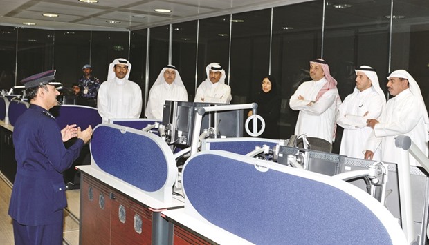 HE the Prime Minister and Minister of Interior Sheikh Abdullah bin Nasser bin Khalifa al-Thani and other ministers being briefed by an official at  the National Command Centre.