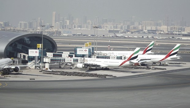 Emirates Airlines aircraft are seen at the Emirates Terminal at Dubai International Airport (file). The worldu2019s biggest international airline may offer premium-economy seats in a reversal of its resistance to a class combining a touch of luxury with reasonable fares as declining oil revenues prompt Middle Eastern customers to tighten travel budgets.