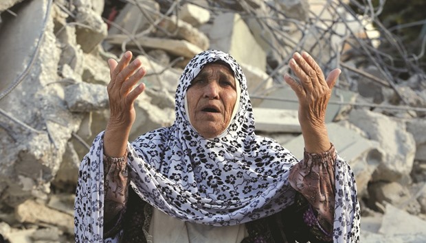 The grandmother of Palestinian assailant Murad Ideis reacts in front of the rubble of his familyu2019s house after it was demolished by Israeli forces in the West Bank village of Yatta, south of Hebron yesterday.
