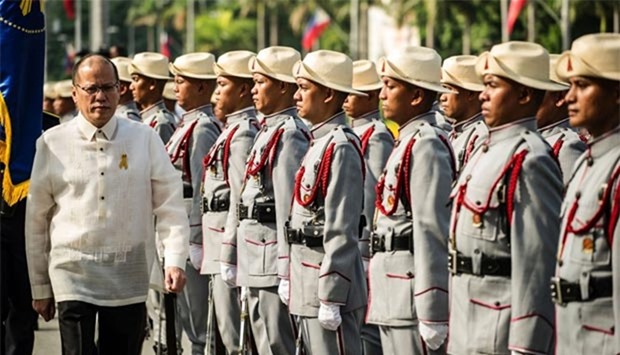 Philippine President Benigno Aquino inspects honour guards near the monument of national hero Jose Rizal during the 118th Independence Day celebration in Manila on Sunday.