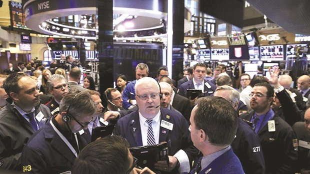 Traders work on the floor of the New York Stock Exchange. Investors are putting record amounts of money into exchange-traded funds as bonds become increasingly difficult to buy and sell.