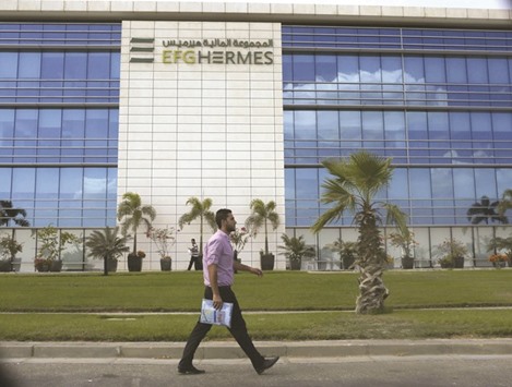 A man walks past EFG-Hermes at the Smart Village, on the outskirts of Cairo (file). Egyptu2019s largest investment bank will reward its shareholders in cash and share buybacks while also pursuing plans to boost capital reserves at subsidiaries in the UAE, Kuwait and possibly Saudi Arabia.