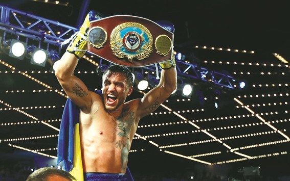 Vasyl Lomachenko holds the championship belt after defeating Roman Martinez by knock out during the fifth round of their Junior Lightweight WBO World Championship bout on Saturday at the Theater at Madison Square Garden in New York City.