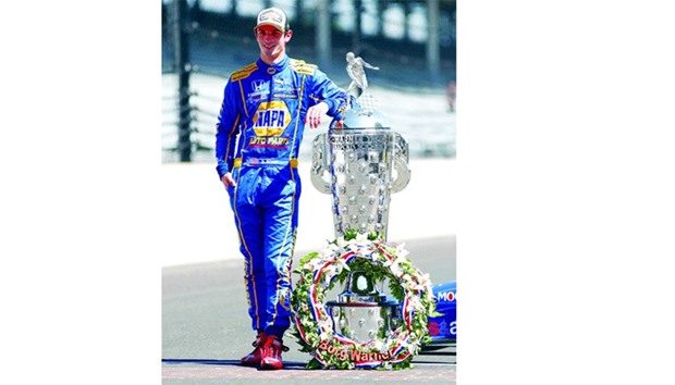 USAu2019s Alexander Rossi poses with the Borg-Warner trophy.