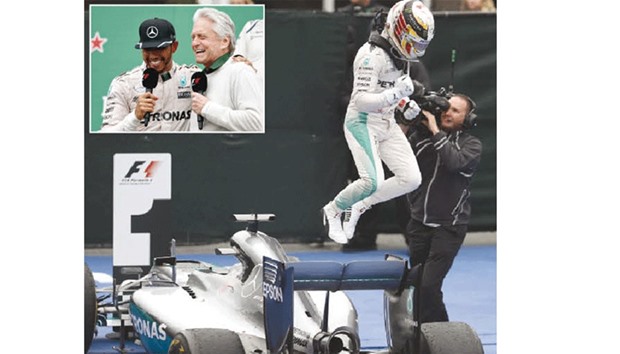 Mercedes driver Lewis Hamilton jumps off his car after winning the Canadian Grand Prix at Circuit Gilles Villeneuve in Montreal, Canada, yesterday. Inset: Hamilton talks to actor Michael Douglas on the podium yesterday. (AFP)