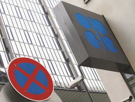 Opec logo is pictured behind a traffic sign at its headquarters in Vienna, Austria, on Monday. Gulf Opec members including Saudi Arabia are looking to revive the idea of coordinated oil-output action by major producers when the group meets today, a senior Opec source said yesterday.